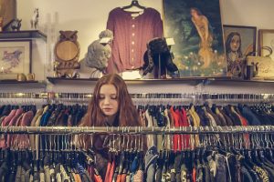 Woman shopping for clothes in a charity shop