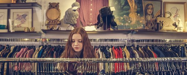 Woman shopping for clothes in a charity shop